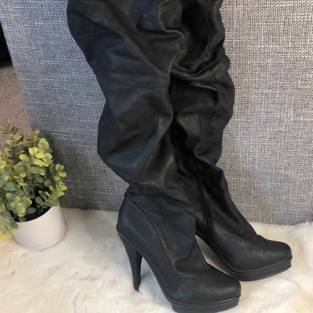 Thigh high boots w/ 4 1/2 inch heel.
